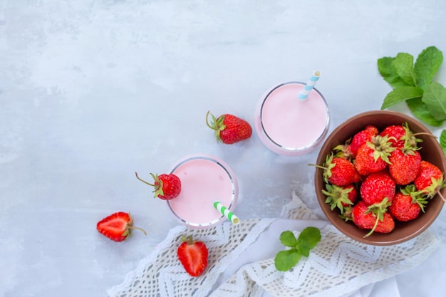 Freshly squeezed strawberry berry cocktail in a glass jar and health or detox diet nutrition concept