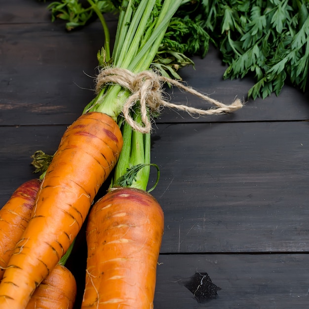 Freshly washed whole carrots with leaves