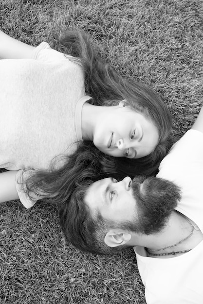 Freshness and peace Hipster bearded man and girl happy carefree enjoy spring nature top view Relax on spring grass Feel free Spring time Youth and freedom Couple in love relaxing lay meadow