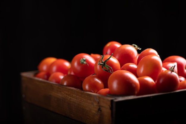 Fressh Red tomatoes box on wooden table