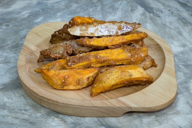 Fried banana fritters on with wood plate