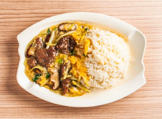 fried beef with egg rice served in dish isolated on table top view of hong kong food