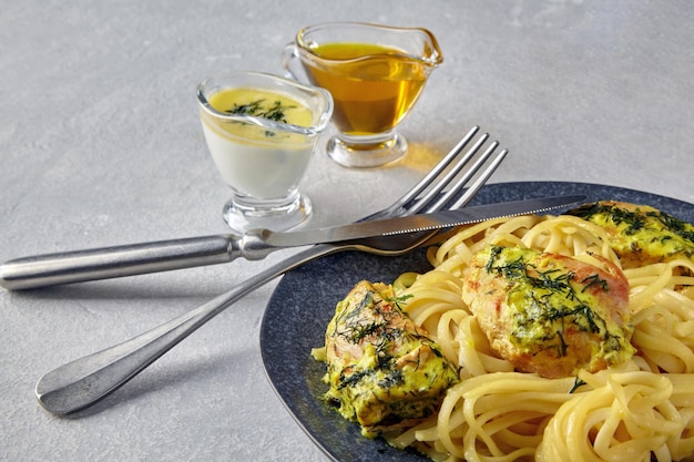 Fried braised chicken breasts with herbs and spices in a creamy milk filling with noodles and gravy boats