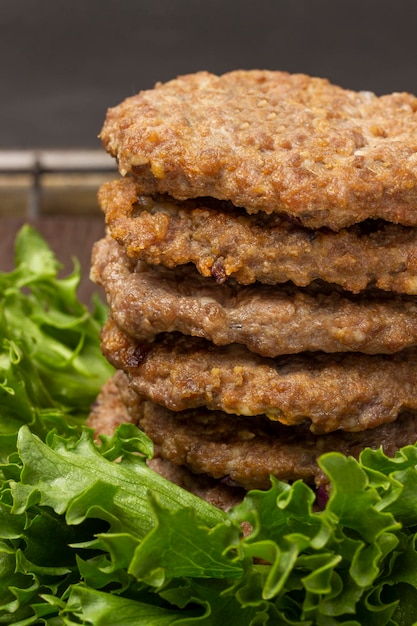 Fried burgers on lettuce leaves Close up