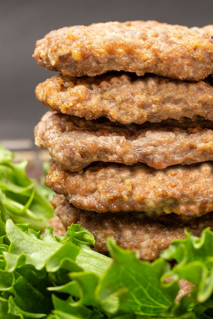 Fried burgers in stack with green salad