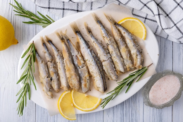 Fried capelin on a white porcelain dish