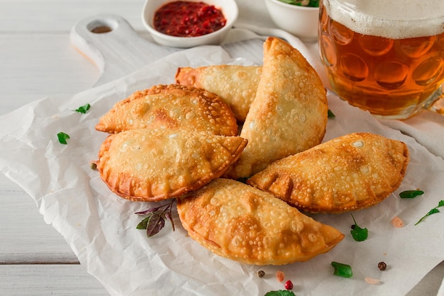 Fried chebureks closeup on a light background no people