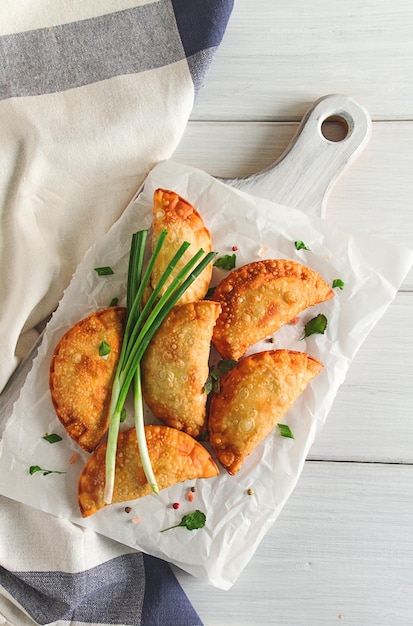 Fried chebureks closeup on a light background no people