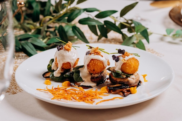 Fried cheese balls are served on a pillow of mushrooms and eggplant ready for eat Restaurant menu