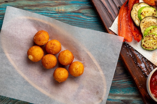 Fried cheese balls served with sauce to the main course