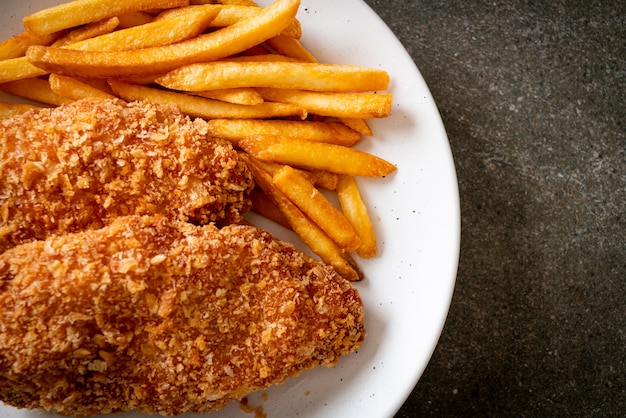 fried chicken breast fillet steak with French fries and ketchup