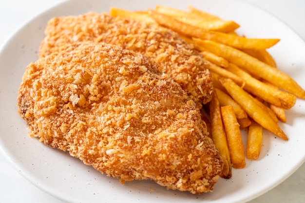 fried chicken breast fillet steak with French fries and ketchup