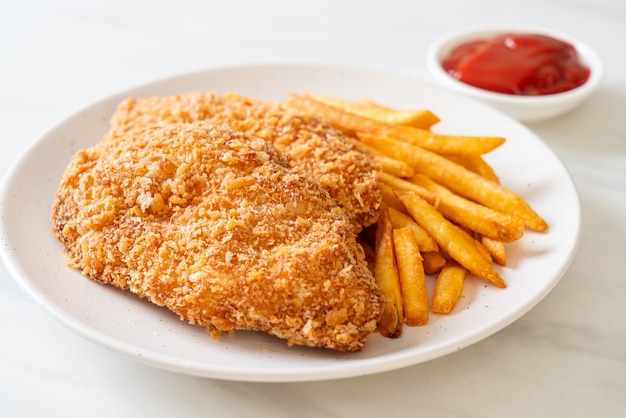 fried chicken breast fillet steak with French fries and ketchup