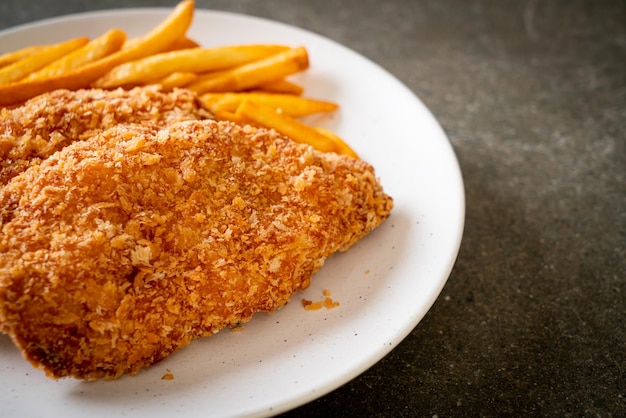 fried chicken breast fillet steak with French fries and ketchup