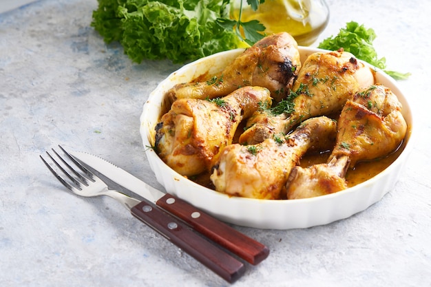 Fried chicken drumstick served in a white bowl