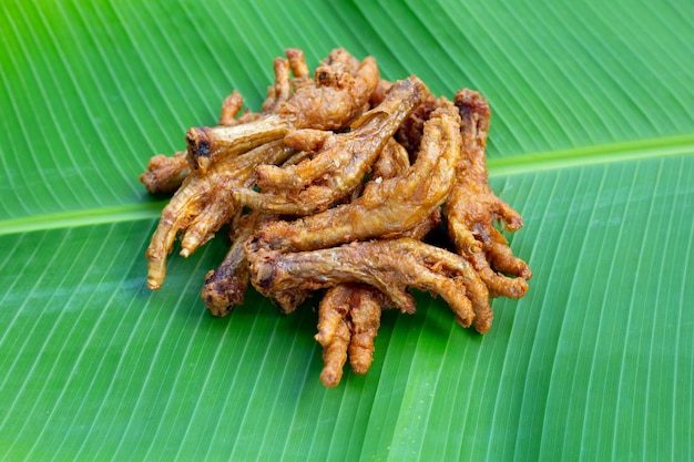 Fried chicken feet on banana leaf