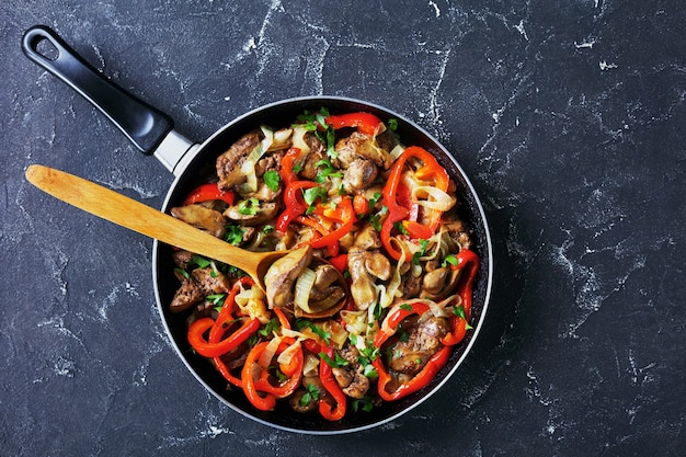 Photo fried chicken liver with onion and sweet pepper