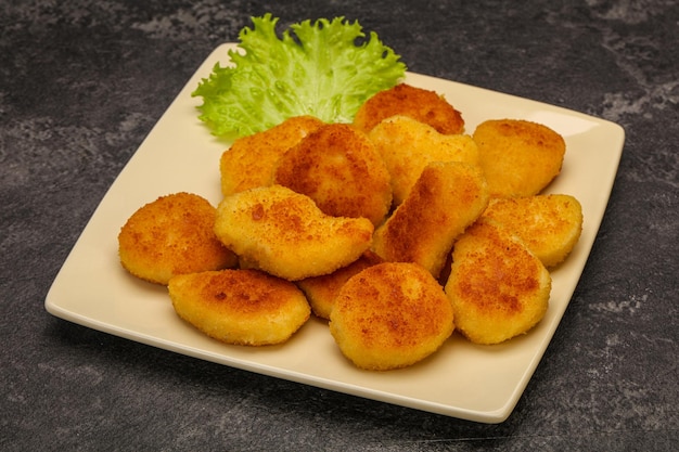 Fried chicken nuggets served salad leaves