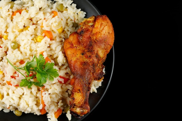 Fried chicken and rice with vegetables in a plate A tasty and hearty dish