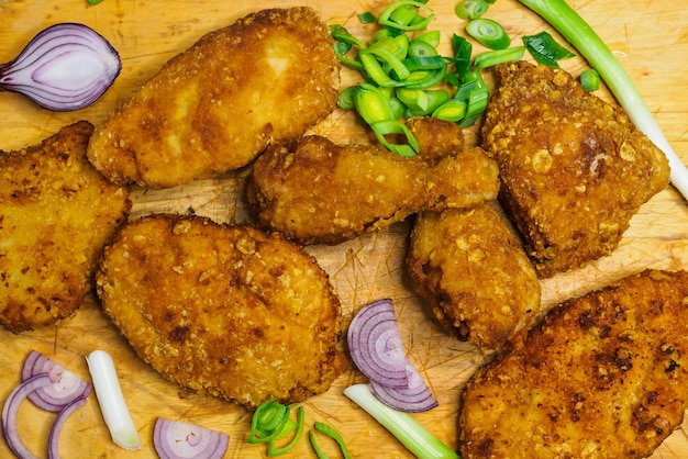 Fried chicken schnitzel on a cutting board Homemade breaded schnitzel Fried crispy chicken legs