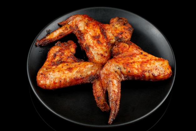 Fried chicken wings on a black plate BBQ Chicken Wings