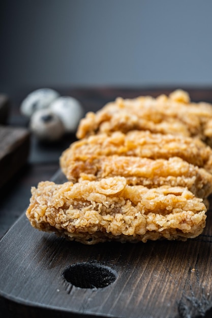 Fried chicken wings on old dark wooden table with copy space