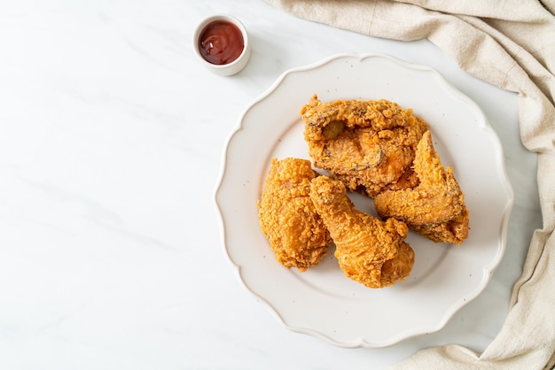 Fried chicken with ketchup on plate