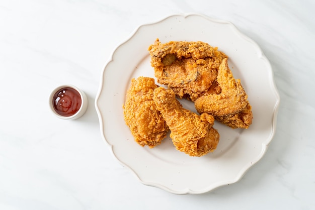 Fried chicken with ketchup on plate