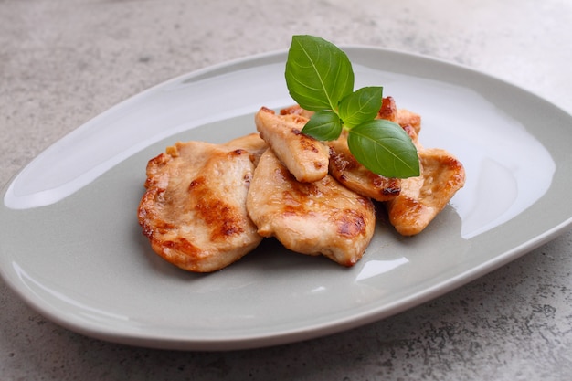 Fried chicken with soy sauce on a plate decorated with sesame seeds