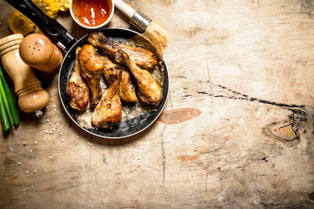 Fried chicken with tomato sauce on a wooden table