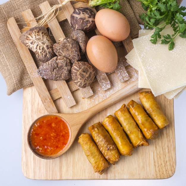 Fried chinese spring rolls with sweet chili sauce.