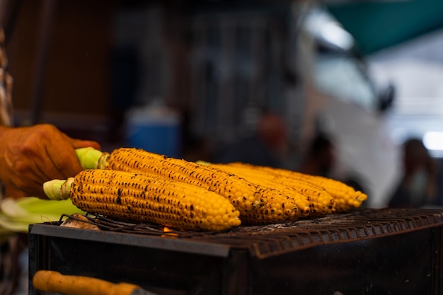 Fried corn on the grill on street. Healthy street food in Turkish market.