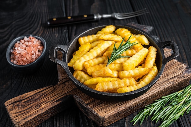 Fried Crinkle French fries potatoes in a pan