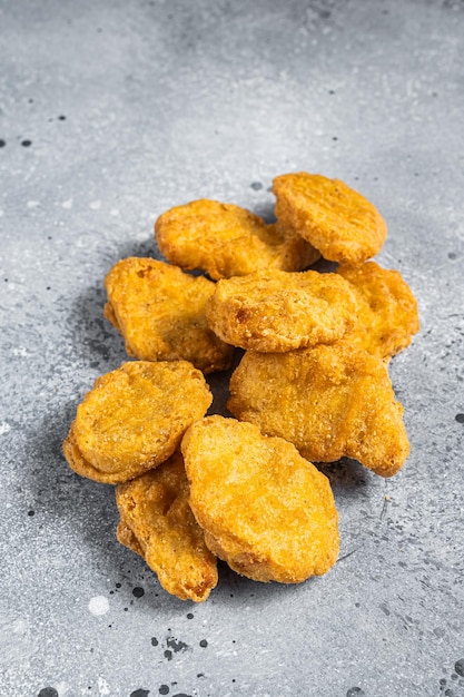 Fried crispy chicken nuggets on kitchen table Gray background Top view