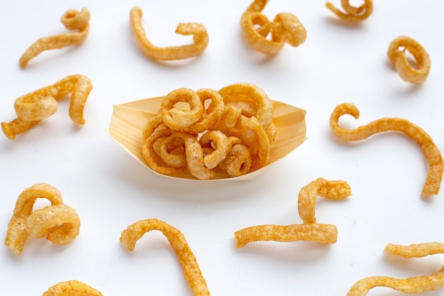 Fried crispy pork rinds on white background.