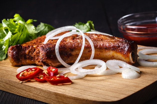 Fried cutlet on the bone on cutting board