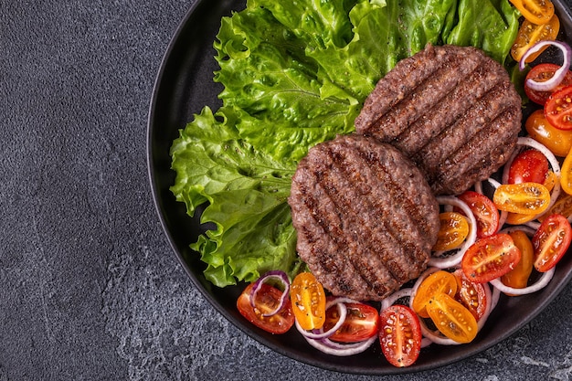 Fried cutlet for burger with vegetables, top view, copy space.