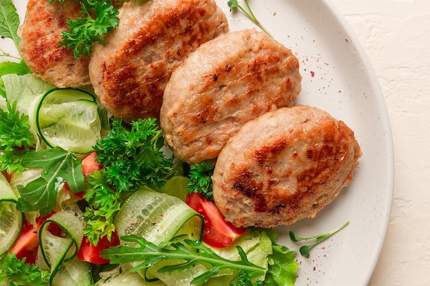 Fried cutlets turkey with vegetable salad top view no people