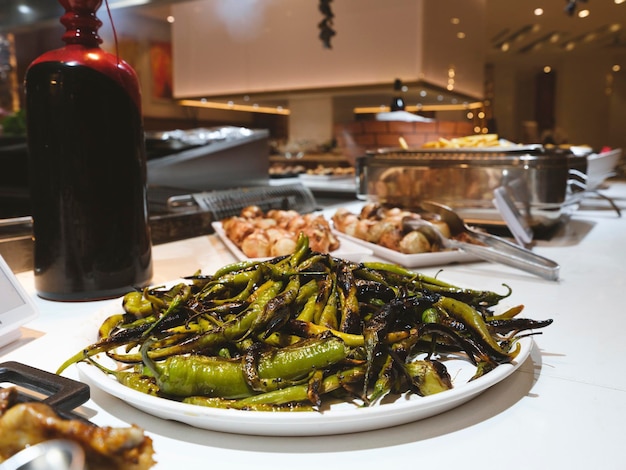 Fried delicious green peppers on the table