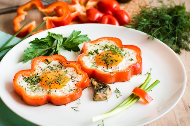 Fried eggs in pepper and herbs on the plate