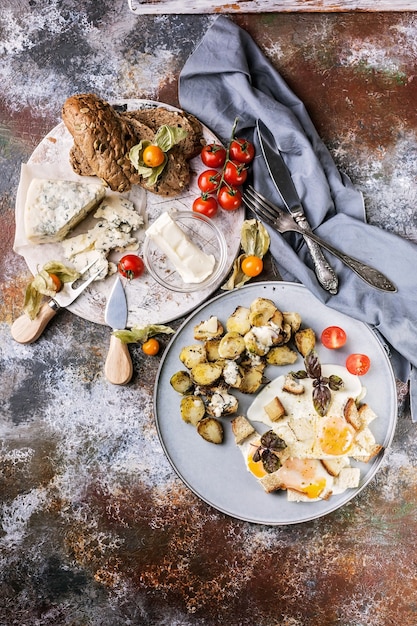 Fried eggs with croutons, sprouts, butter, cheese and a baguette with pumpkin seeds