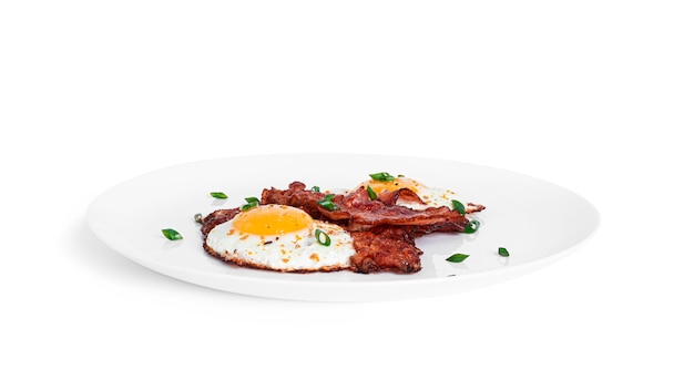 Fried eggs with fried bacon isolated on a white background. High quality photo