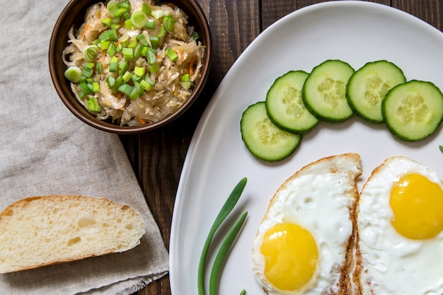 Fried eggs with green onions and cucumber.