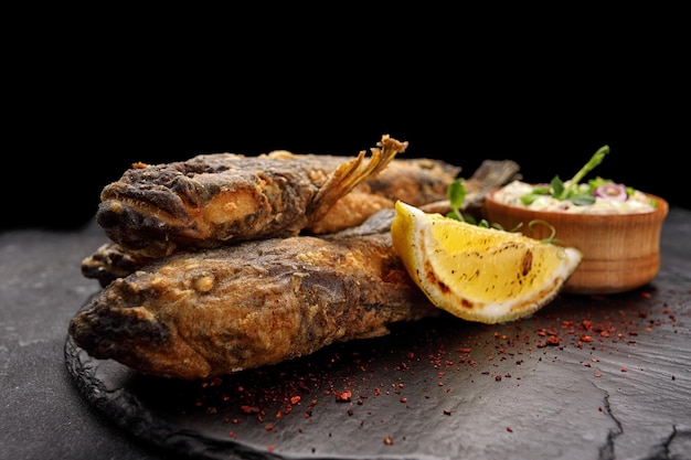 Fried fish Black Sea goby on a dark background