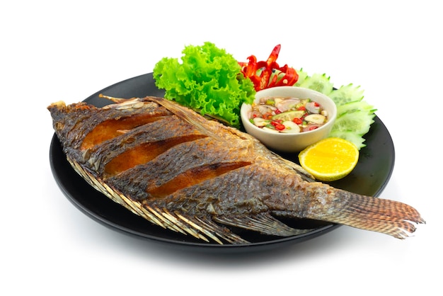 Fried Fish Served Sweet Chili Fish Sauce Thaifood popular Street food Style decoration carved chili and vegetables sideview