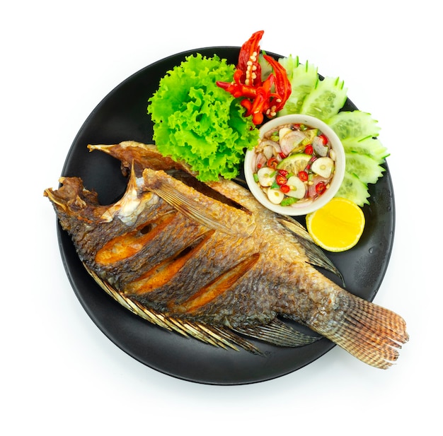 Fried Fish Served Sweet Chili Fish Sauce Thaifood popular Street food Style decoration carved chili and vegetables topview