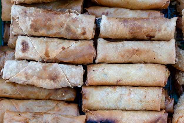 Fried flour roll for sell in street food market Thailand closeup wrapped pancakes