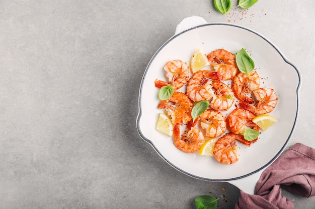 Fried fresh shrimps with spices on white pan 