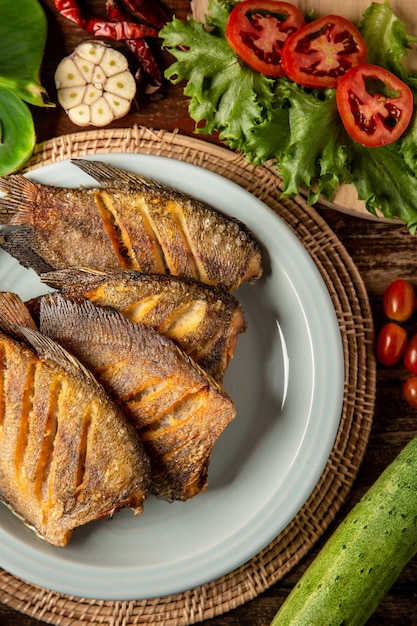 Fried gourami on the table and vegetables