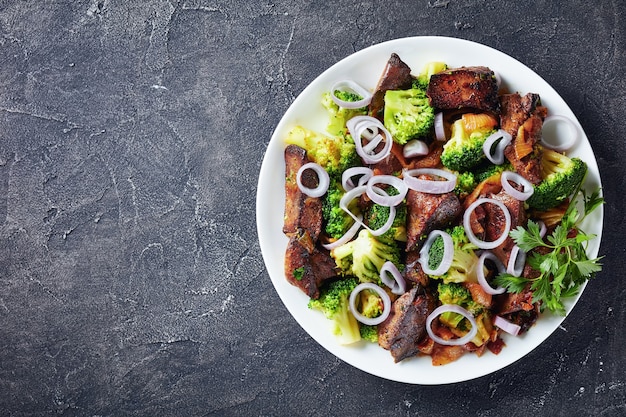 Fried liver with broccoli on a plate